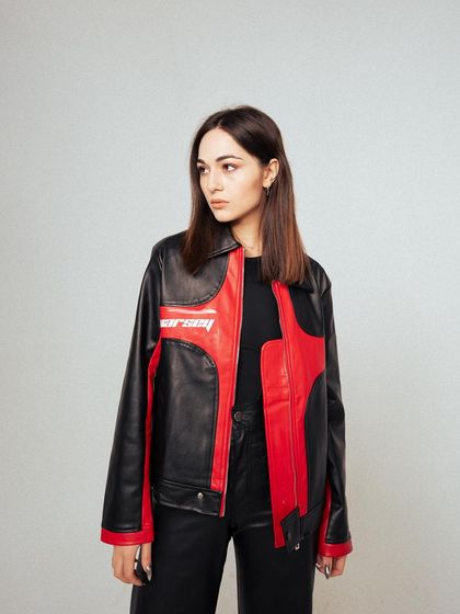 A classic three-quarter profile shot. This provides a clear view of the jacket's side details and branding, essential for product-focused photography.