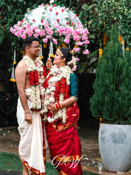 A playful and romantic moment under a custom floral umbrella. This is one of the unique, personal touches we love to add to make a couple's day even more special.