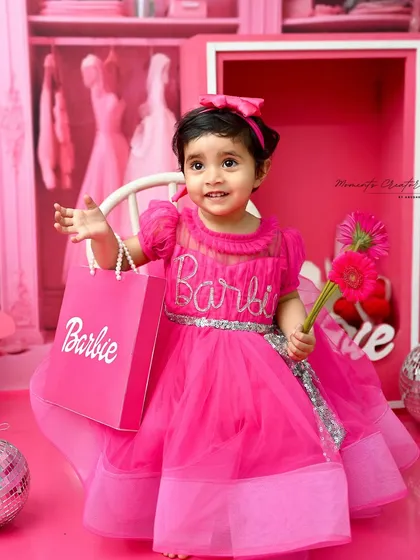 A real-life Barbie doll, ready for a day of fun. This shot captures her sweet personality in a room filled with all things pink and fabulous.