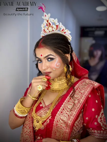 A playful and coy portrait of a Bengali bride. This shot captures the personality and emotion of the moment, an important aspect of bridal photography and makeup.