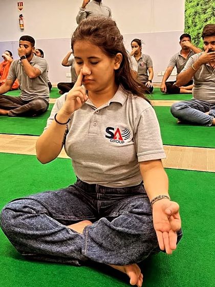 A student at a corporate session deeply focused on her pranayama practice. Taking a few moments to breathe consciously can completely change your state of mind.
