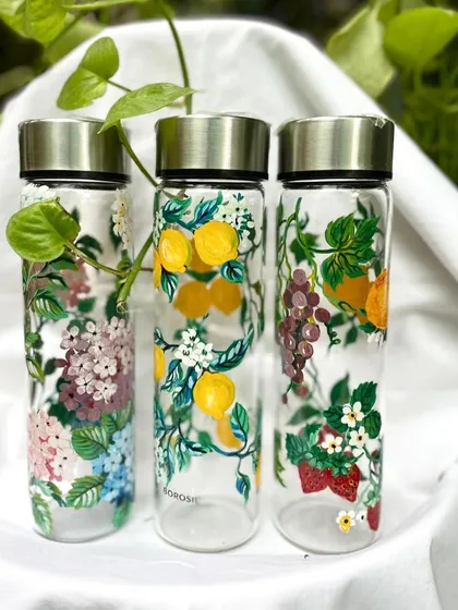 My mom painted these beautiful Borosil glass bottles with lemons, fruits, and hydrangeas. The detail is just incredible.
