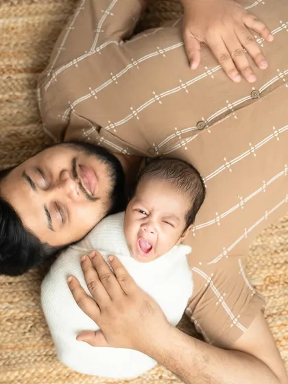 A sleepy yawn from the little one. Sometimes the most candid moments are the cutest, like this father and baby relaxing together.