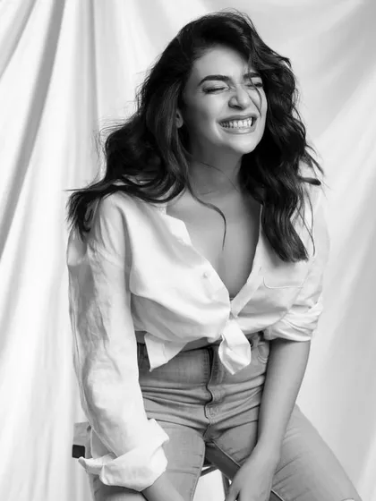 The joy on a client's face says it all. Here, I created a textured cut with face-framing layers, styled into effortless beach waves. This look is all about creating natural volume and a relaxed, happy vibe.
