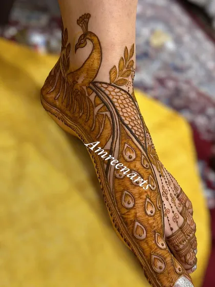 A side view of the peacock foot design, showing how the feathers gracefully curve around the ankle.