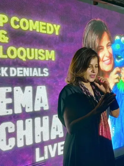 A moment from my live show in Bangalore. The backdrop shows my branding, which I use for both public comedy shows and private corporate entertainment gigs.