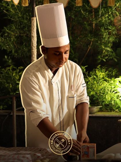 A chef working at night at an outdoor station, focused and dedicated to his craft. Our team works tirelessly to ensure your event is perfect.