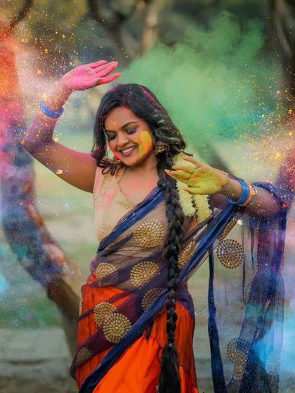 A joyful, dancing pose that perfectly captures the festive spirit of Holi.