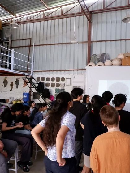 A group of students gathered around for a demonstration. Sharing knowledge and seeing the spark of understanding is one of the best parts of teaching.