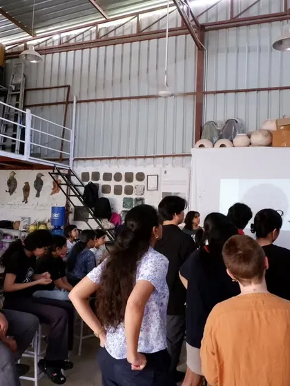 A group of students gathered around for a demonstration. Sharing knowledge and seeing the spark of understanding is one of the best parts of teaching.