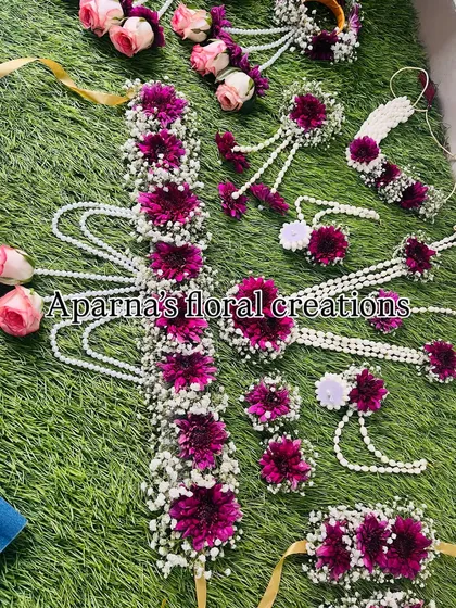 An overhead view of the complete magenta and pink floral set, showing the floral belt, haath phool, and all other matching pieces.