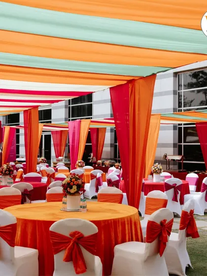 We design vibrant and comfortable spaces for every pre-wedding function. This outdoor Mehendi setup used a colorful canopy of drapes and coordinated table settings to create a festive and welcoming atmosphere for guests.