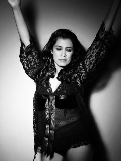 A joyful and free black and white portrait. Her pose is uninhibited, a celebration of self-love and confidence.