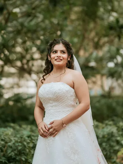 A beautiful outdoor portrait. The makeup is subtle and elegant, perfect for a daytime wedding, ensuring the bride looks and feels her best.