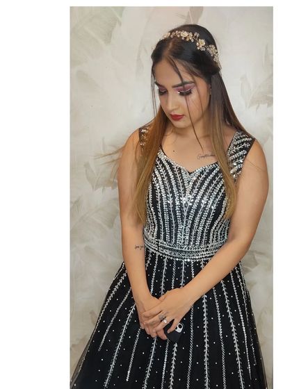 This black and silver gown features vertical sequin stripes, creating a slimming and elegant silhouette.