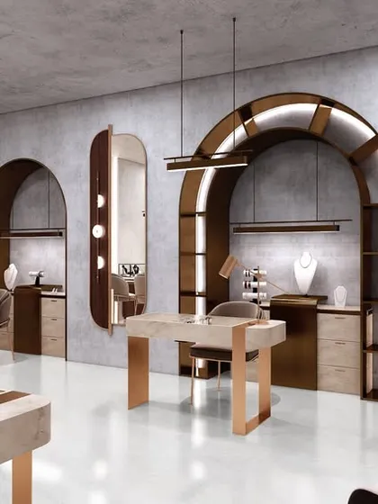 A wide view of the studio, showing the various display cases and seating areas. The design uses a monotonous palette with metallic finishes to create a sense of refinement and luxury.