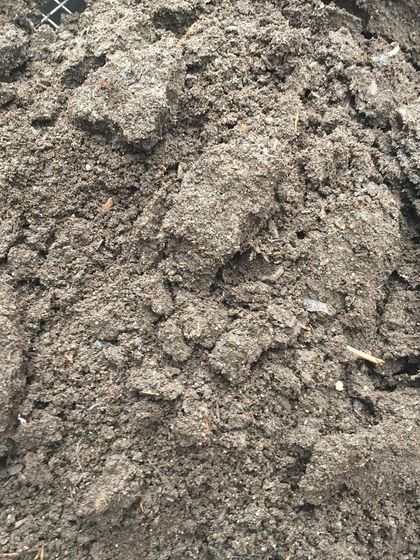 This is the unsifted compost, full of larger chunks of organic matter. While it's still breaking down, it shows the raw ingredients that eventually become our finished product.