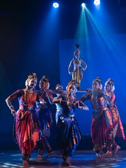 A creative choreographic moment where our dancers carry a representation of Bala Krishna (child Krishna). This illustrates our innovative approach to traditional storytelling.