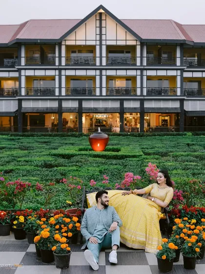 A relaxed moment in the beautiful gardens of the Mayfair Siliguri. The grand architecture and vibrant flowers create a stunning backdrop for this candid portrait.