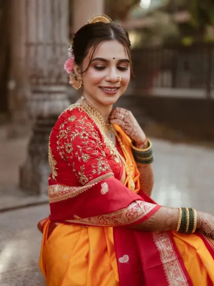 The intricate details of the embroidered blouse and the soft, romantic hairstyle with a fresh flower make this look truly special.
