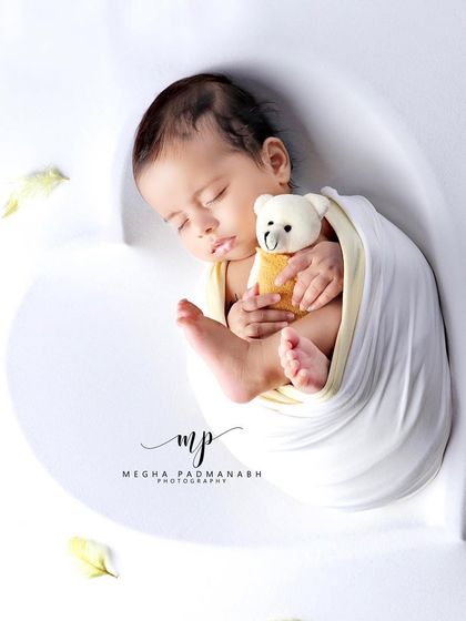 Another angle of the baby and bear, showing the soft textures of the setup.