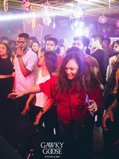 A candid moment of laughter and dancing on the floor.