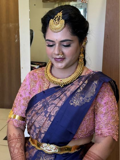 A close-up of Gowthami's makeup, showing the soft eyeshadow and the traditional nose ring.