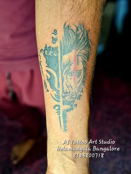 A creative half-face tattoo combining a deity with a lion, symbolizing divine power and courage.