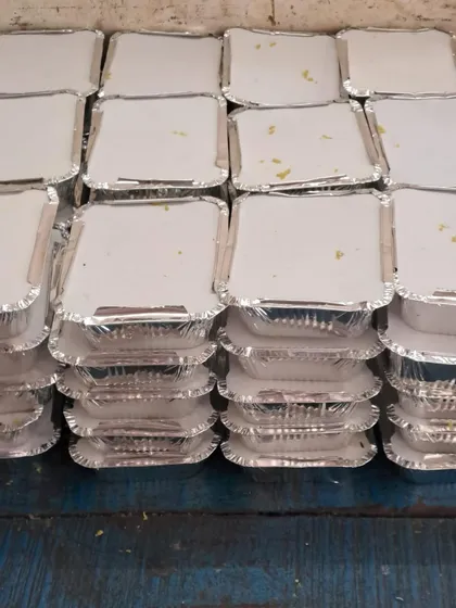 Stacks of freshly packed meals, sealed and ready for dispatch. We can handle high volume orders with ease.