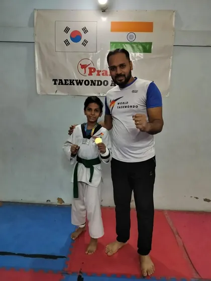 A green belt student with his well-earned gold medal.