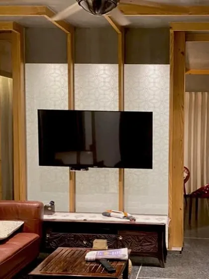 The 'lantern' partition in the Lucknow penthouse also serves as a feature wall for the entertainment center, integrating technology seamlessly into the crafted, atmospheric design.