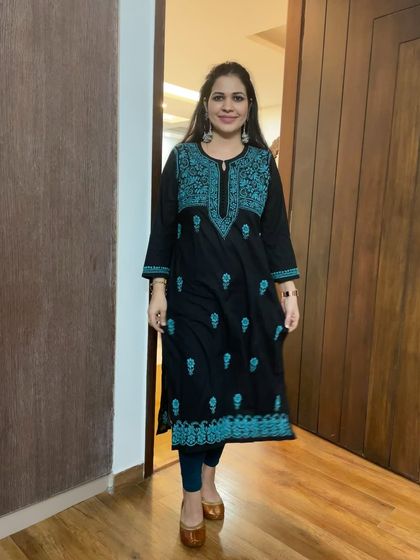 A classic black Chikankari kurti with contrasting teal embroidery. This is a versatile piece that can be dressed up or down for any occasion.