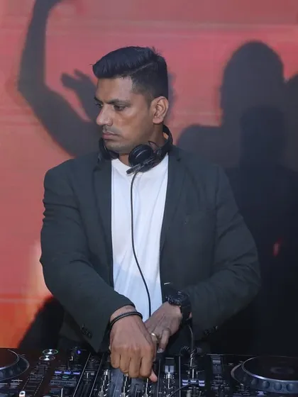 In the zone at a corporate event, with silhouettes of dancers on the screen behind me. This highlights my VJ skills, where the visuals are always in sync with the music.