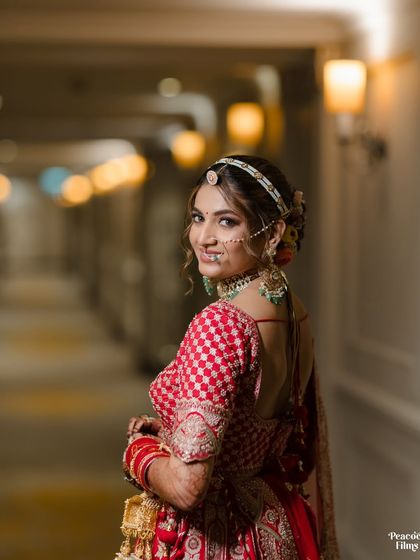 A beautiful over-the-shoulder shot of the bride, her smile lighting up the frame. A classic and charming bridal portrait.