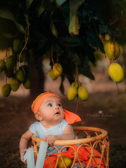 Looking up in wonder at the mangoes. The natural light and beautiful scenery make outdoor shoots so special.