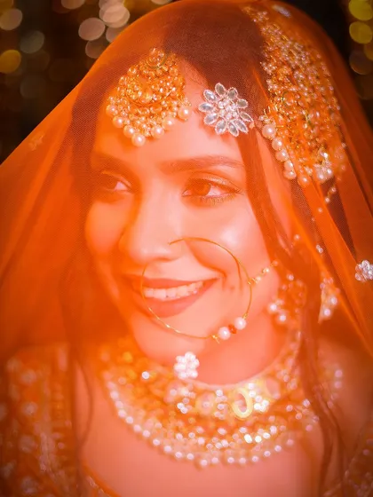 A happy, smiling portrait captured through the veil, giving the photo a soft and joyful feel.