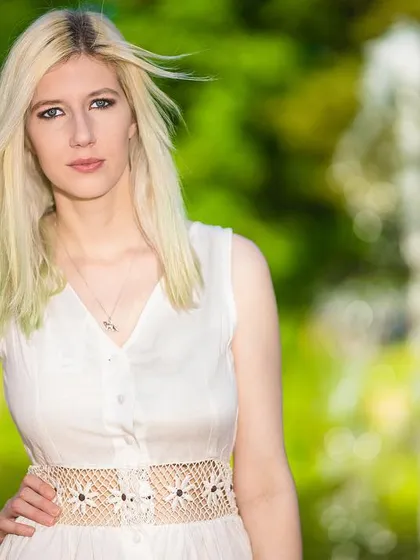 For this shot, I used a fountain to create a soft, out-of-focus background, which makes the model stand out. The slight breeze adding movement to her hair gives the portrait a dynamic, natural feel.