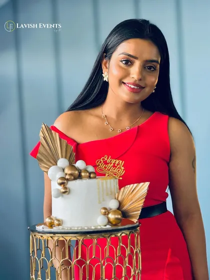 The birthday girl with her elegant white and gold cake that perfectly matches the decor.