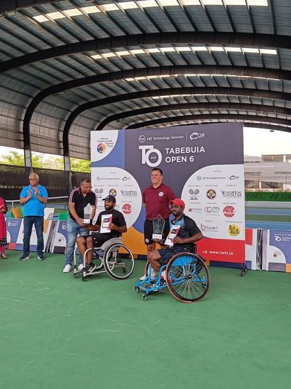 The men's doubles winners receive their trophies at the Tabebuia Open. Hosting competitive tournaments is key to our mission of growing the sport of wheelchair tennis.