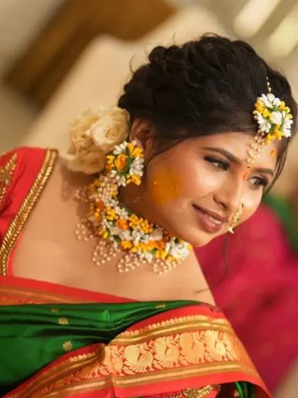 A close-up of the Haldi look, showing the glow of the skin and the intricate floral necklace.