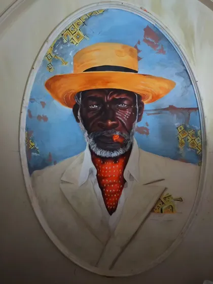 A straight-on shot of the Cuban portrait, showing the incredible detail in the painting and relief work. This piece demonstrates our skill in combining sculpture and painting to create hyper-realistic and impactful characters.