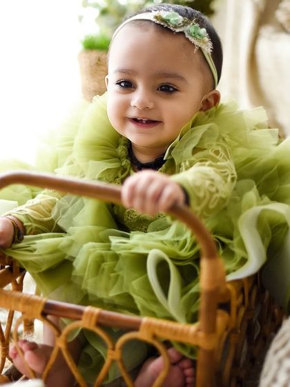 A happy smile from inside a rustic cane basket. Using props like this can help keep babies engaged and adds a lovely textural element to the photograph.