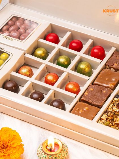 A luxurious Raksha Bandhan gift hamper, filled with bonbons, fudge, granola bars, and coated nuts. It's the ultimate indulgence for your sibling.