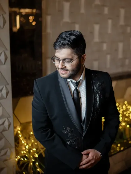 A stylish groom ready for his reception party. The lighting highlights the sharp cut of his suit and the clean finish of his makeup.