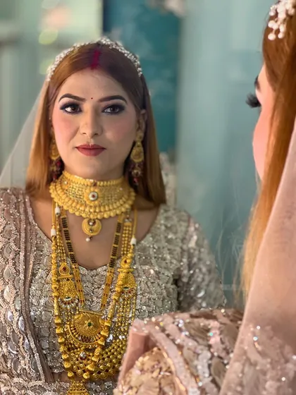 A mirror shot of the reception bride, reflecting her beauty and the intricacy of her jewelry.