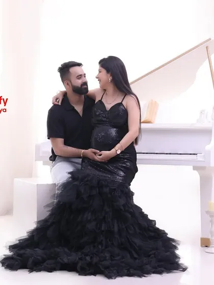 A sweet, seated pose on the piano bench. This shot captures the couple's happy and relaxed interaction during their studio session.