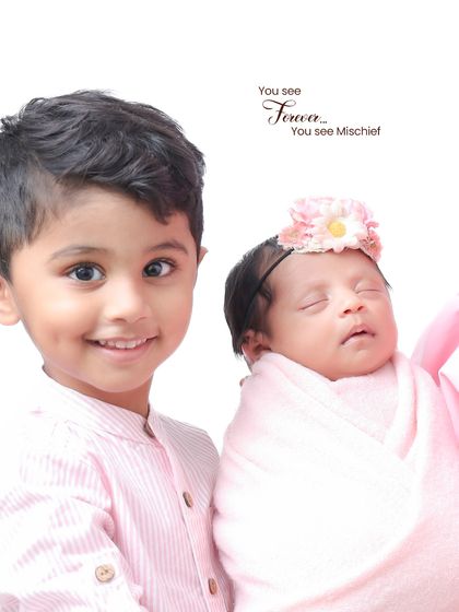 A proud big brother with his new baby sister. This shot captures the sweet and sometimes mischievous energy that a new sibling brings to the family.