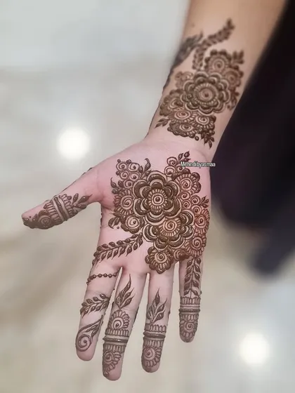 A lovely floral piece on the palm and wrist. This is a great option for someone who wants a design that's not too heavy.