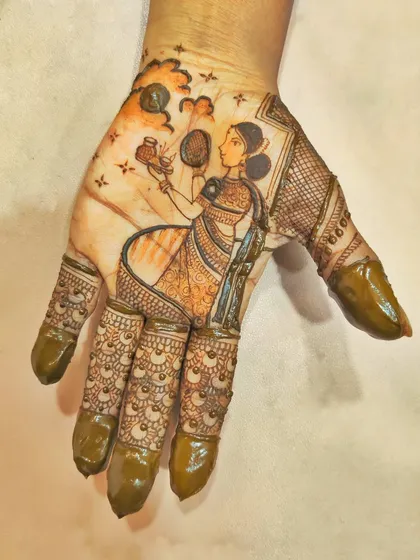 I focused on a single, large figure for this Karwa Chauth piece. The woman holding a pot and looking at the moon fills the entire palm, with delicate details in her saree and jewelry.