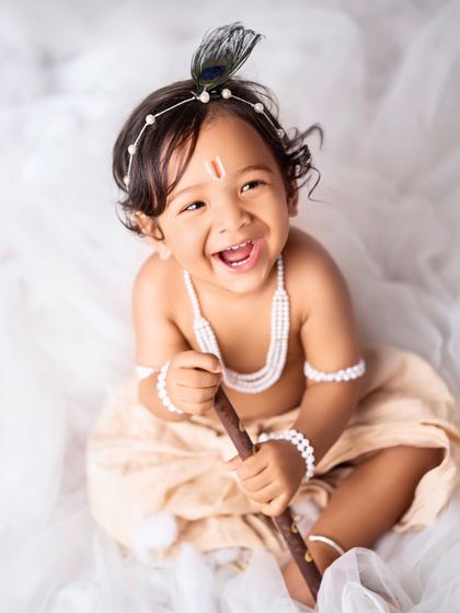 A happy little Krishna, laughing with joy. These mini sessions are a wonderful way to celebrate Janmashtami.